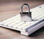 a computer keyboard with a padlock on top of it
